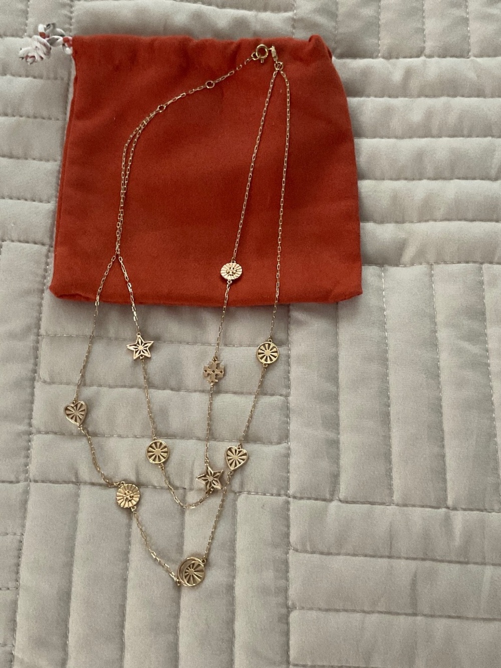 Tory Burch gold tone double layered necklace with charms.